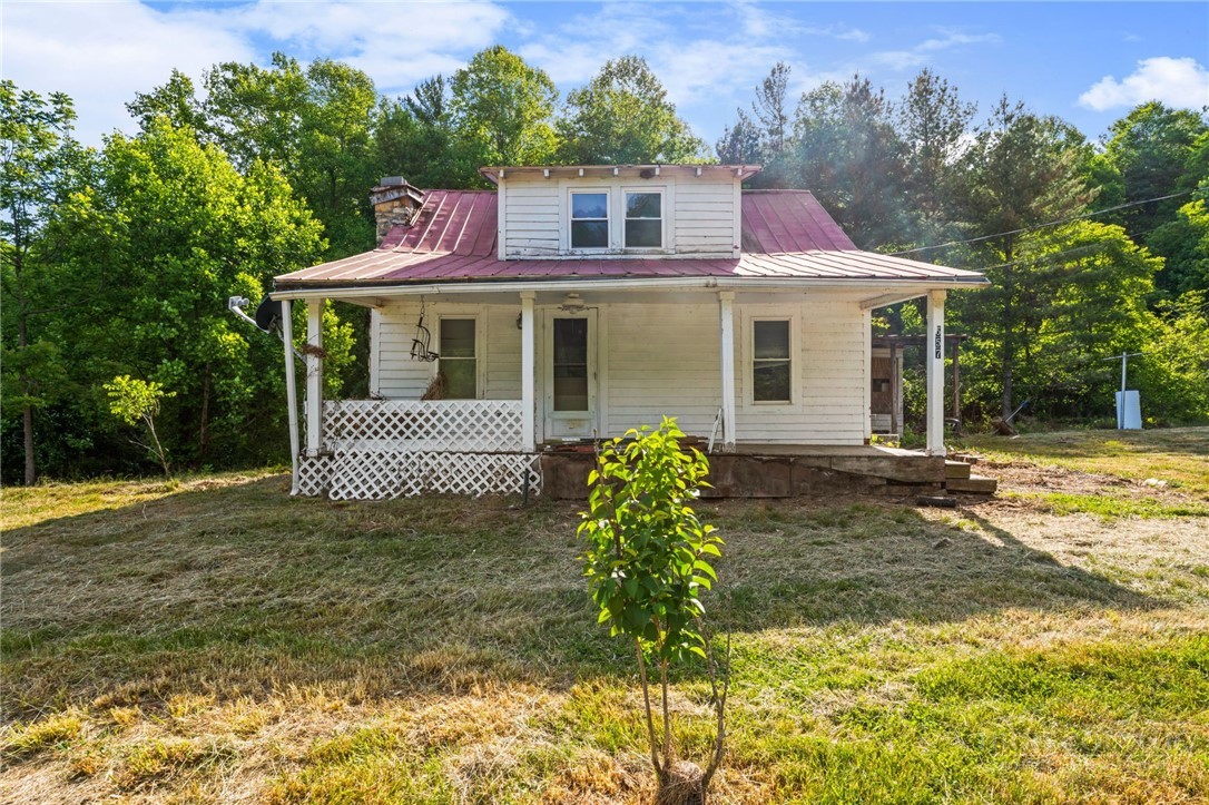 657 Lawrence Greene Road Deep Gap, NC 28618 - Photo 18 of 25 a front view of a house with garden