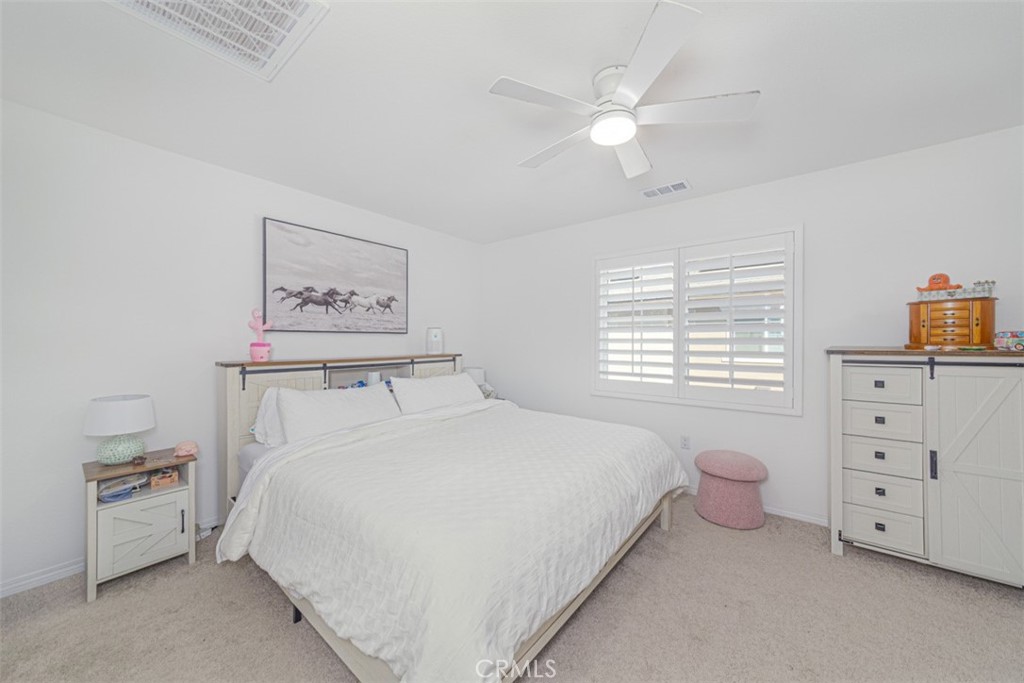 7395 Olive Grv Street Riverside, CA 92507 - Photo 12 of 18 Spacious primary room uptairs with ceiling fan and plantation shutters.