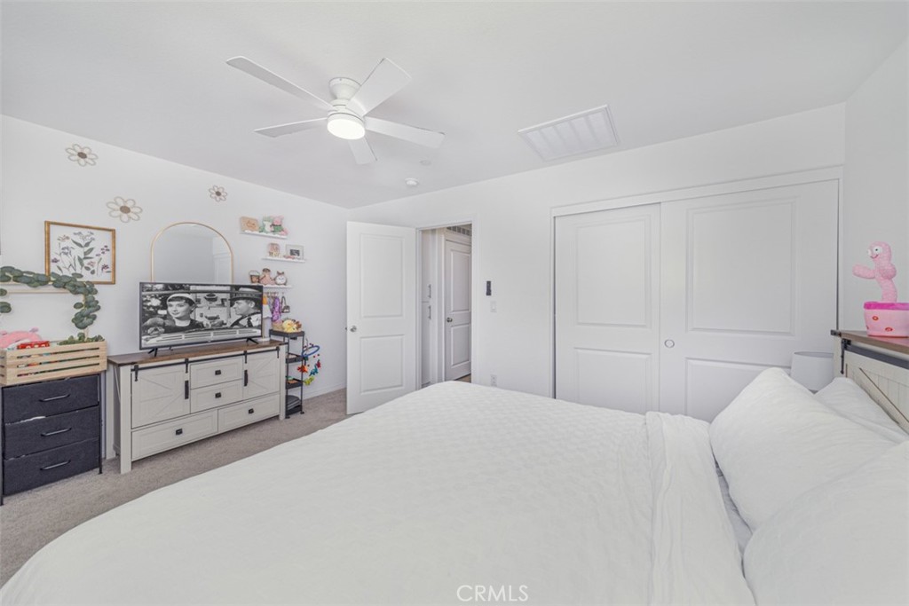 7395 Olive Grv Street Riverside, CA 92507 - Photo 13 of 18 Spacious primary room uptairs with ceiling fan and plantation shutters.