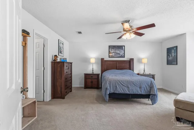 a bedroom with a bed couches and window