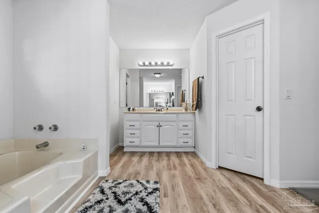 a bathroom with a bathtub and a sink