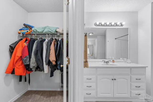 a bedroom with a bed and a table with closet