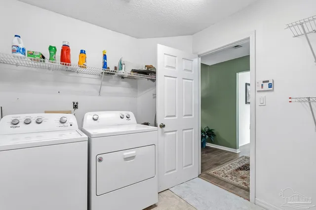 a view of a deck with chairs a barbeque with wooden floor and fence
