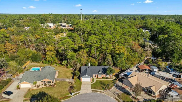 an aerial view of a house with swimming pool and garden space