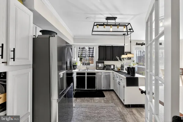 a kitchen with stainless steel appliances kitchen island granite countertop a refrigerator and a stove