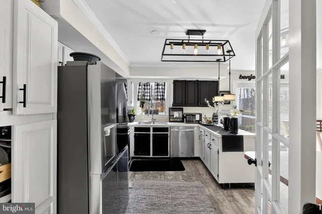 a kitchen with stainless steel appliances kitchen island granite countertop a refrigerator and a stove