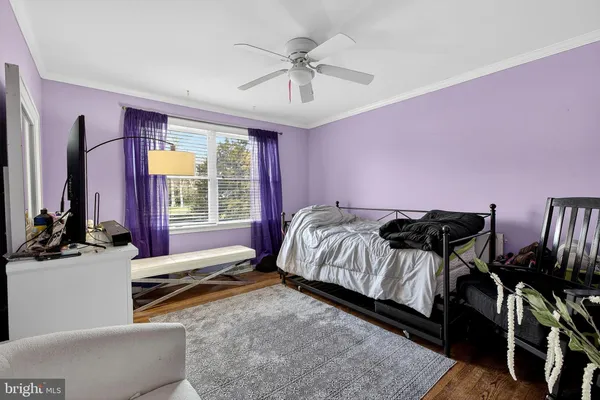 a bed room with a bed and a chair
