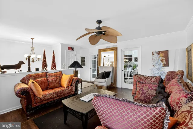 a living room with furniture a rug and a chandelier