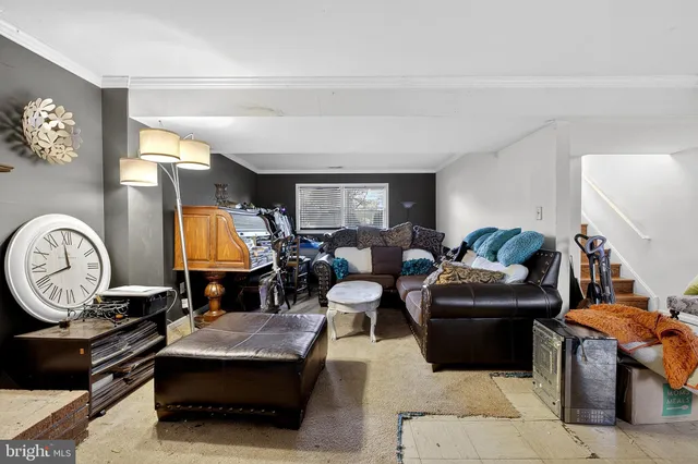 a living room with furniture a fireplace and a window