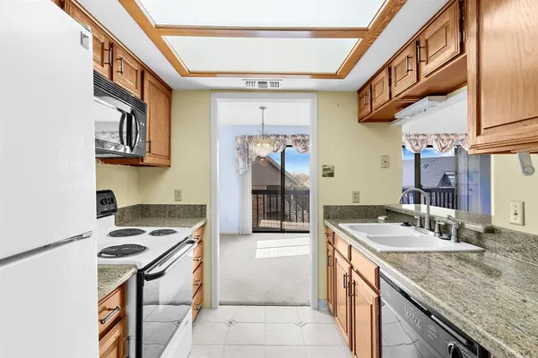 a kitchen with a sink a stove and cabinets