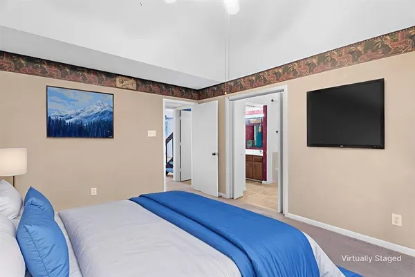 a bedroom with a bed and a flat screen tv