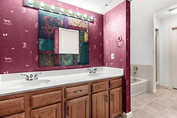 a bathroom with a sink vanity and a mirror