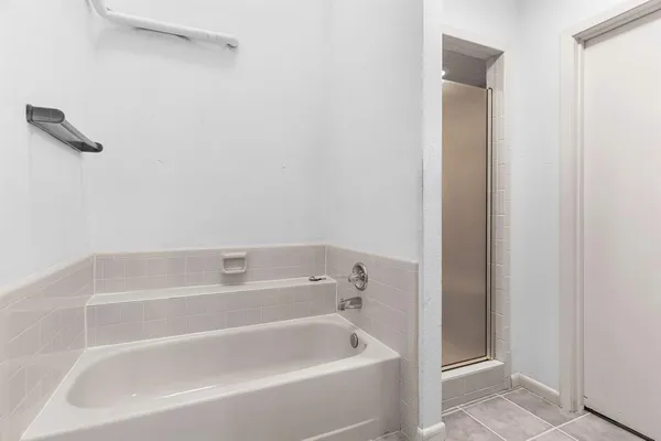 a white bath tub sitting next to a white sink