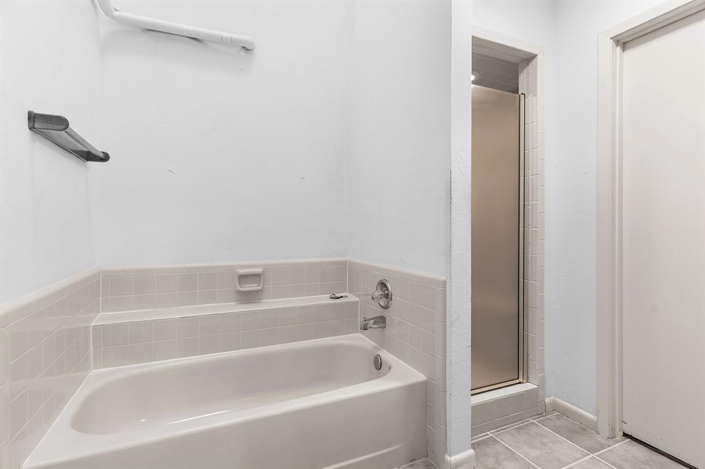 1048 Signal Ridge Place Rockwall, TX 75032 - Photo 19 of 40 a white bath tub sitting next to a white sink