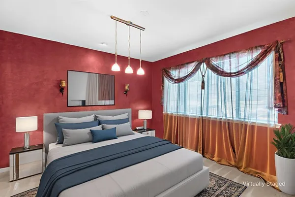 a bedroom with furniture and a large window