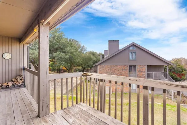 a view of wooden house with a small yard