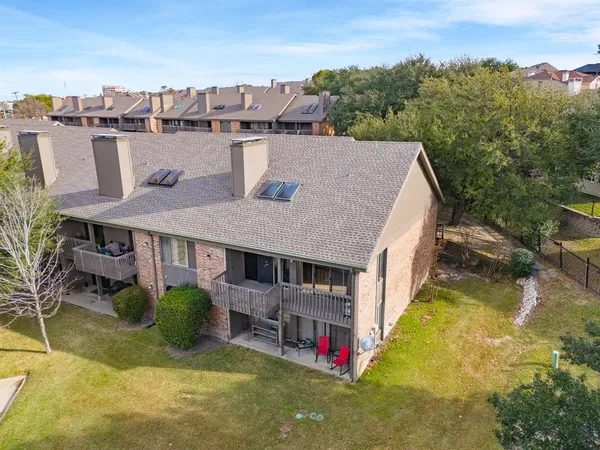a aerial view of a house with swimming pool and a yard