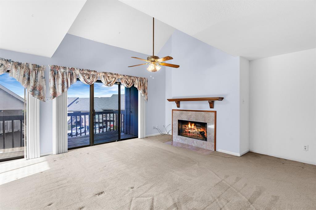1048 Signal Ridge Place Rockwall, TX 75032 - Photo 4 of 40 a view of an empty room with a fireplace and a window