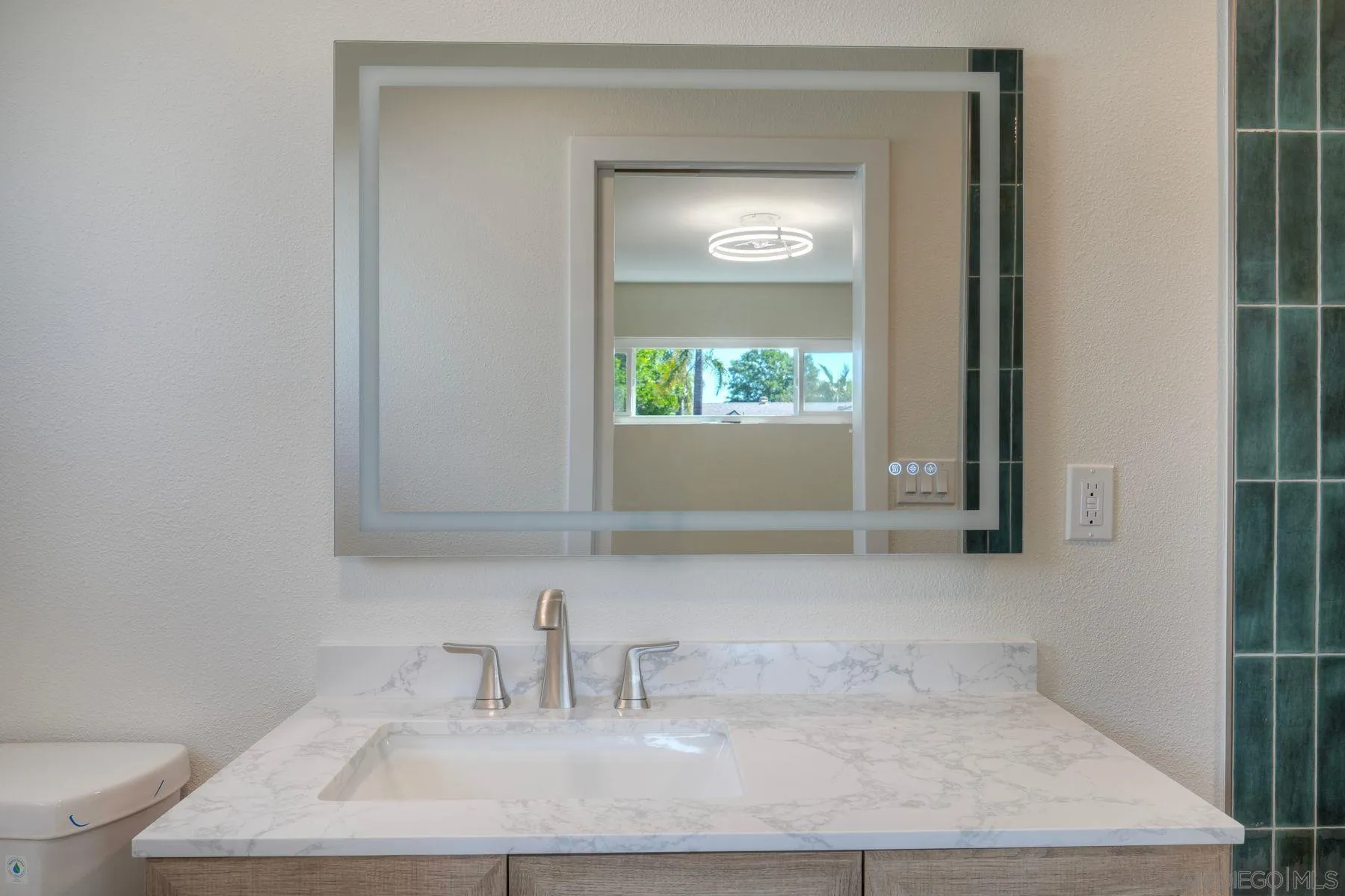 578 East Indian Rock Road Vista, CA 92084 - Photo 13 of 30 a bathroom with a sink a toilet and a mirror