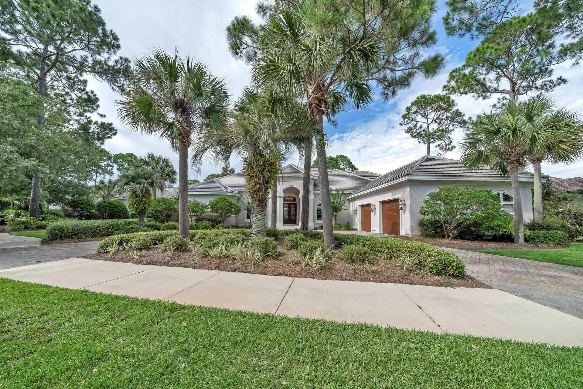 2958 Pine Valley Road Miramar Beach, FL 32550 - Photo 78 of 96 a front view of a house with a yard and potted plants