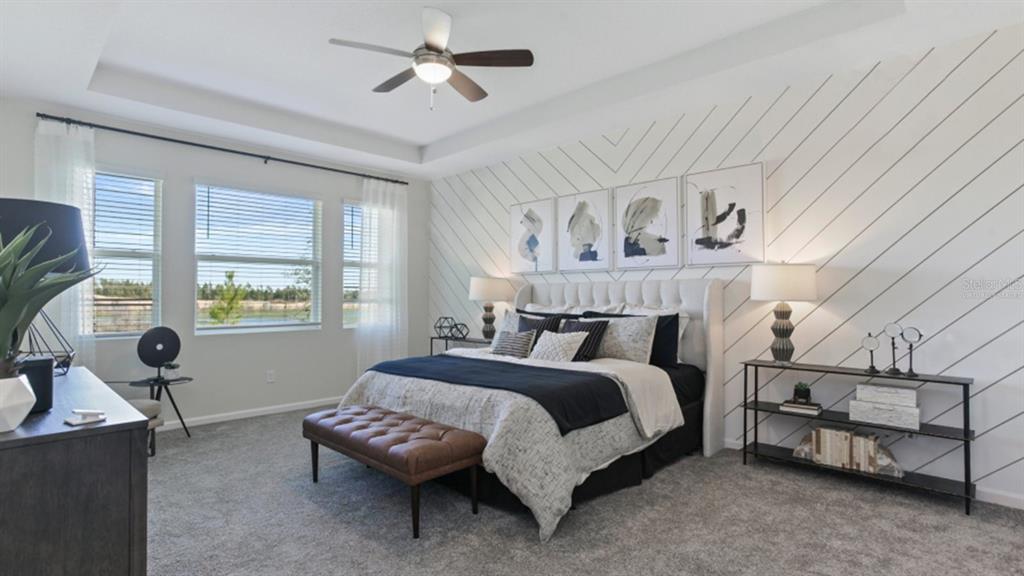 1696 Rider Rain Lane Apopka, FL 32703 - Photo 12 of 19 a spacious bedroom with a bed and a window