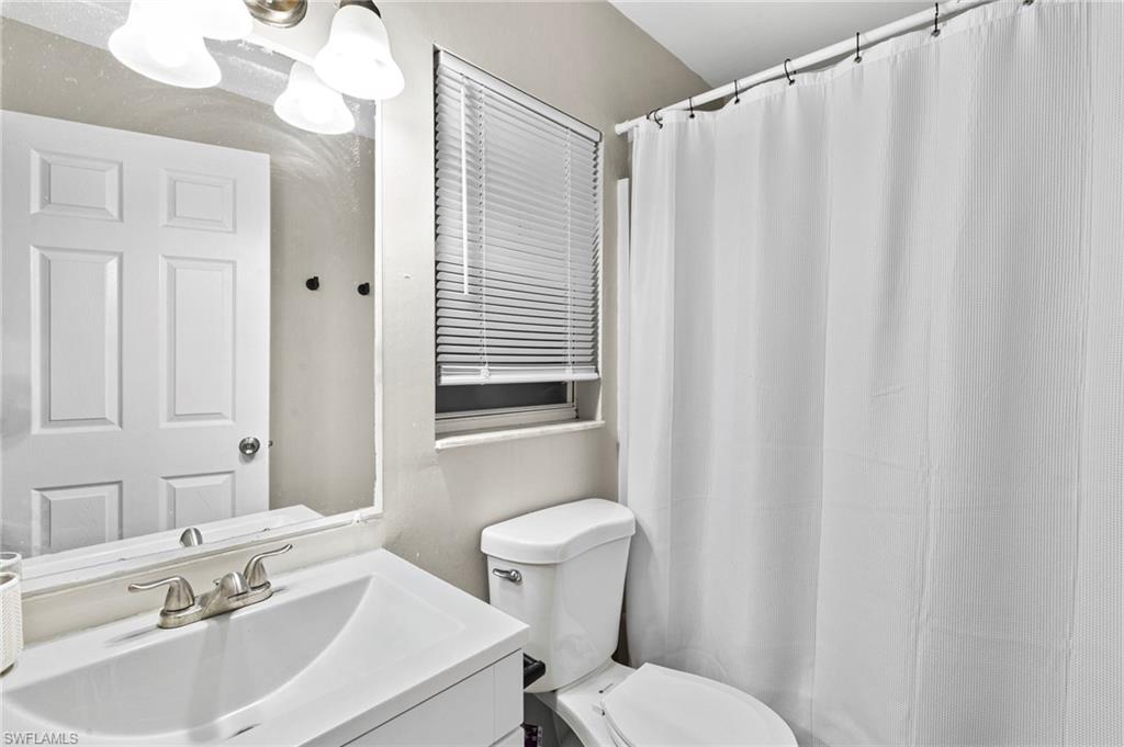 8264-8268 Matanzas Road Fort Myers, FL 33967 - Photo 11 of 33 a bathroom with a sink a toilet and shower curtain
