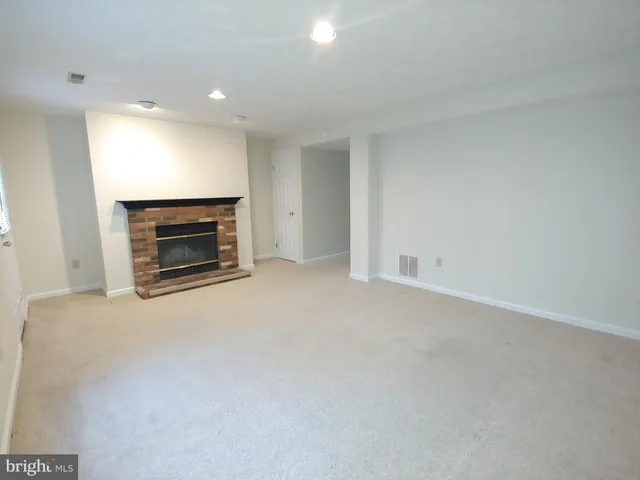 an empty room with a fireplace