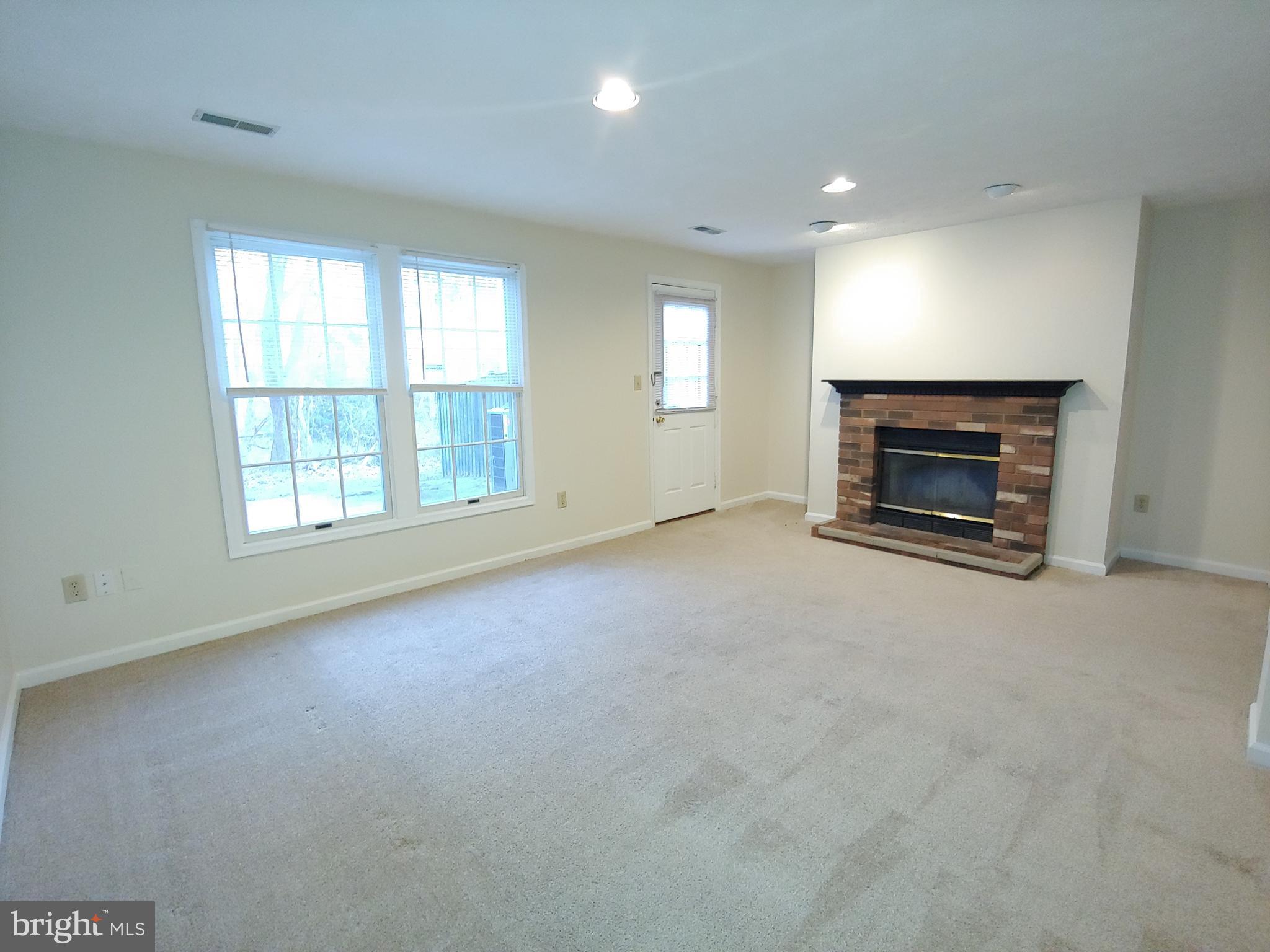 2134 Commissary Circle Odenton, MD 21113 - Photo 22 of 41 an empty room with fireplace and windows