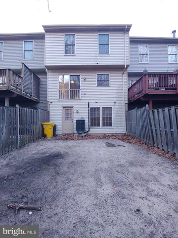 a view of a house with a backyard and a large tree