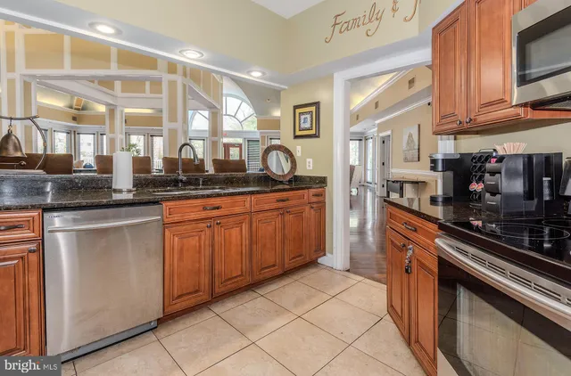 a kitchen with granite countertop a sink and cabinets