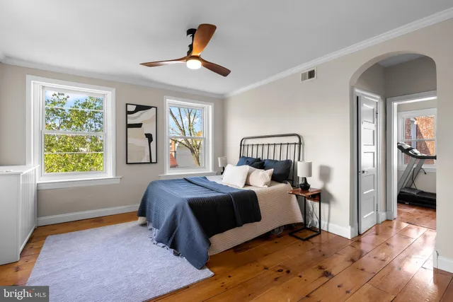 a bedroom with a large bed and a large window