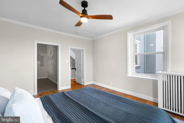 a view of a hallway with wooden floor and chandelier