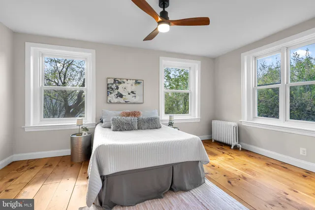 an empty room with a window and wooden floor