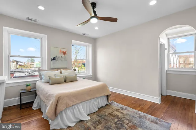 a kitchen with stainless steel appliances kitchen island granite countertop a refrigerator a sink a stove a dining table and chairs