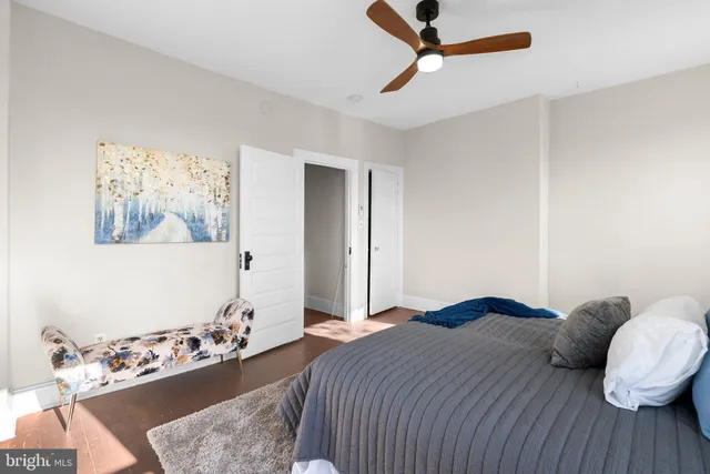 a bed sitting in a bedroom next to a blue wall