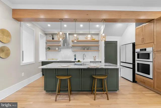 a kitchen with granite countertop a sink cabinets and stainless steel appliances