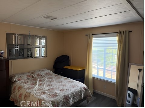 2751 South Reche Canyon Road, Unit 162 Colton, CA 92324 - Photo 9 of 11 a bedroom with a bed and a window