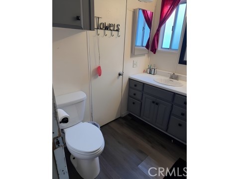 2751 South Reche Canyon Road, Unit 162 Colton, CA 92324 - Photo 10 of 11 a bathroom with a sink vanity mirror and toilet