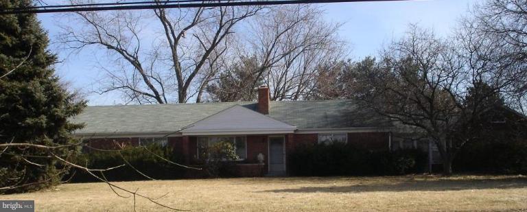 7000 Warfield Road Gaithersburg, MD 20882 - Photo 1 of 12 a house with trees in front of it