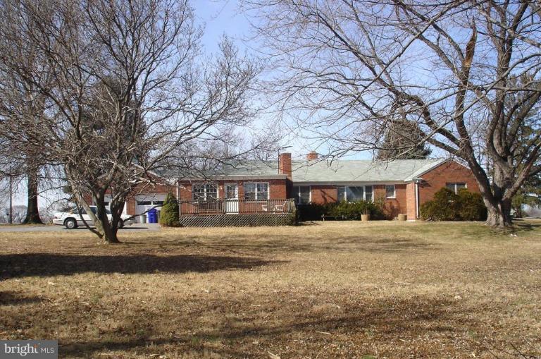 7000 Warfield Road Gaithersburg, MD 20882 - Photo 2 of 12 a front view of residential houses with yard and trees