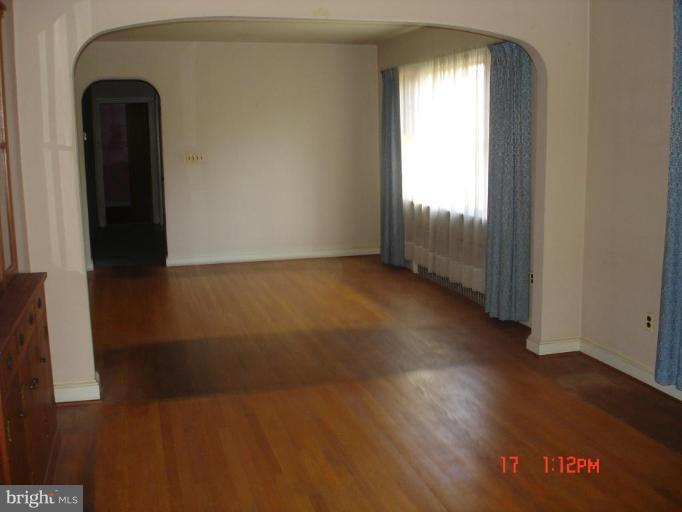 7000 Warfield Road Gaithersburg, MD 20882 - Photo 9 of 12 an empty room with wooden floor and windows