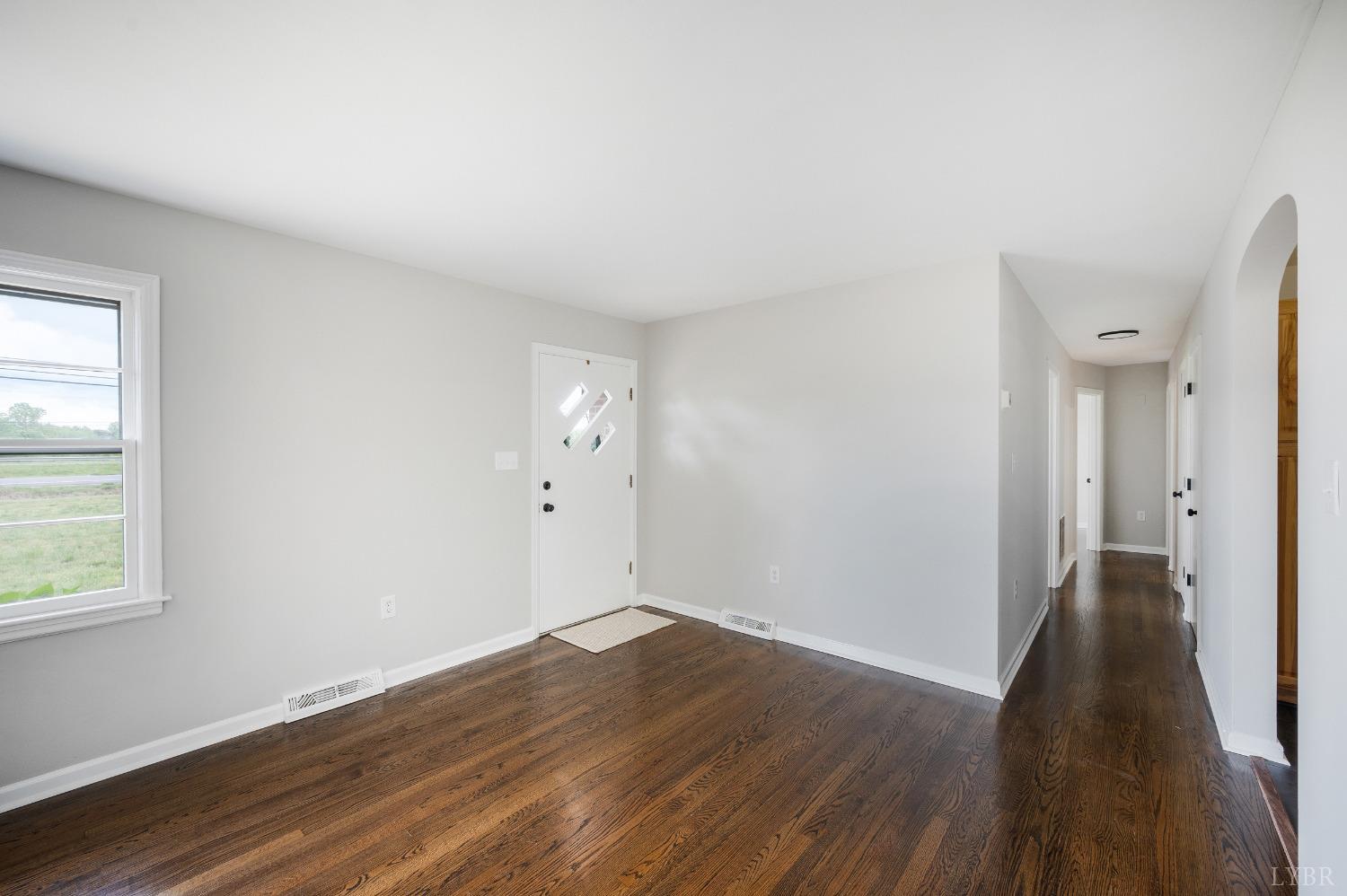 7230 Wards Road Rustburg, VA 24588 - Photo 12 of 58 an empty room with wooden floor and windows