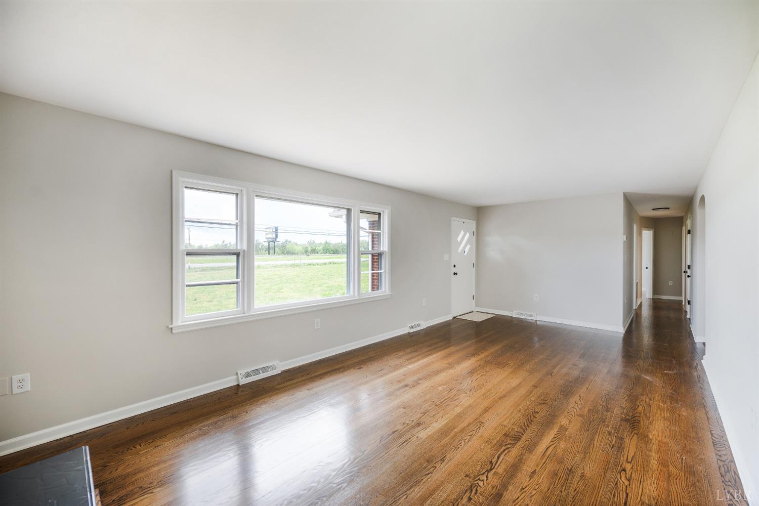 7230 Wards Road Rustburg, VA 24588 - Photo 15 of 58 an empty room with wooden floor and windows