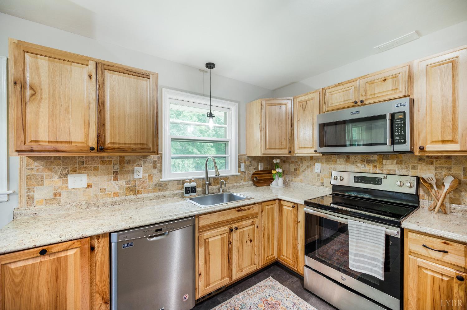 7230 Wards Road Rustburg, VA 24588 - Photo 17 of 58 a kitchen with stainless steel appliances a stove sink microwave and cabinets