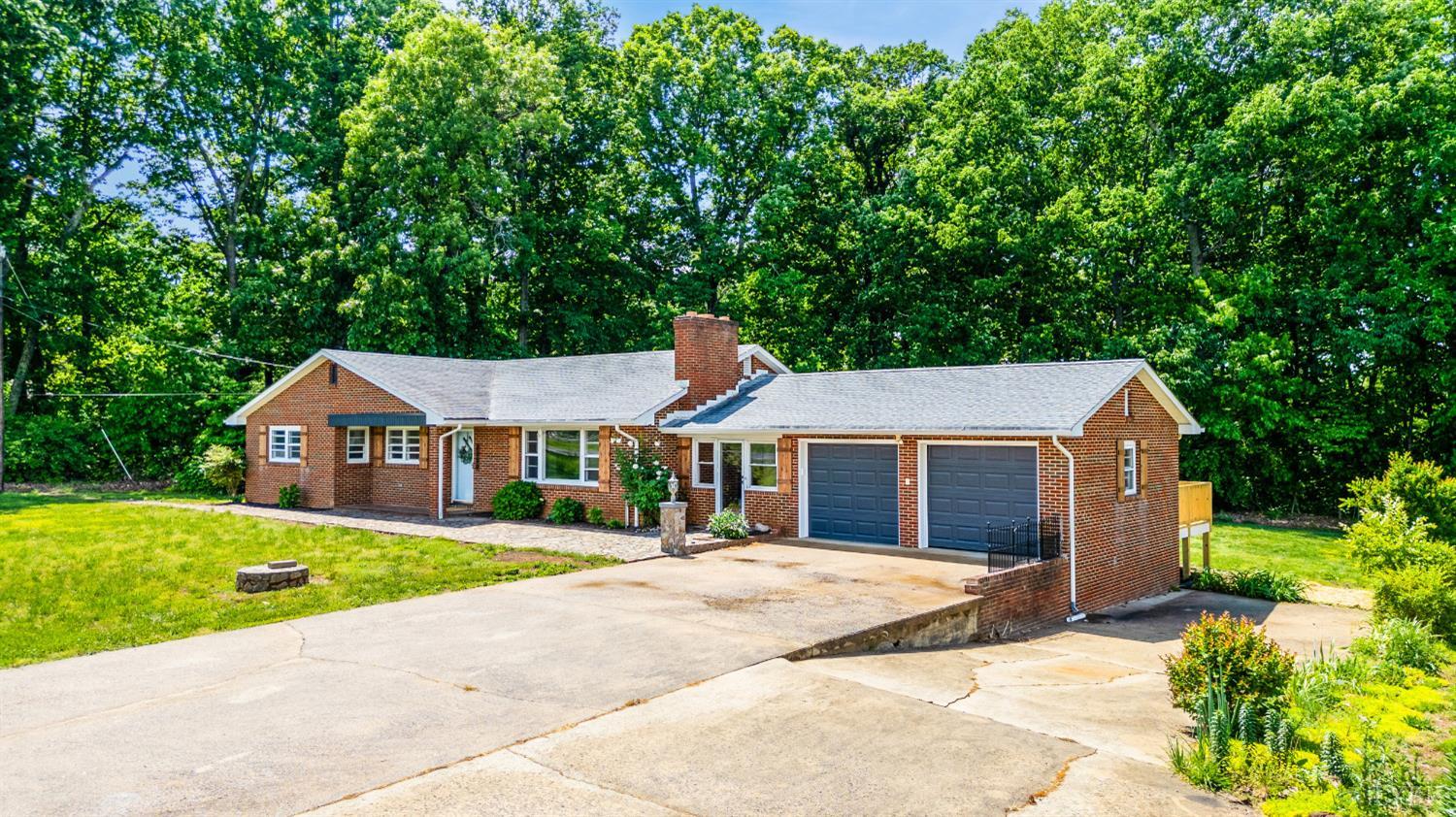 7230 Wards Road Rustburg, VA 24588 - Photo 2 of 58 a front view of a house with a garden and yard