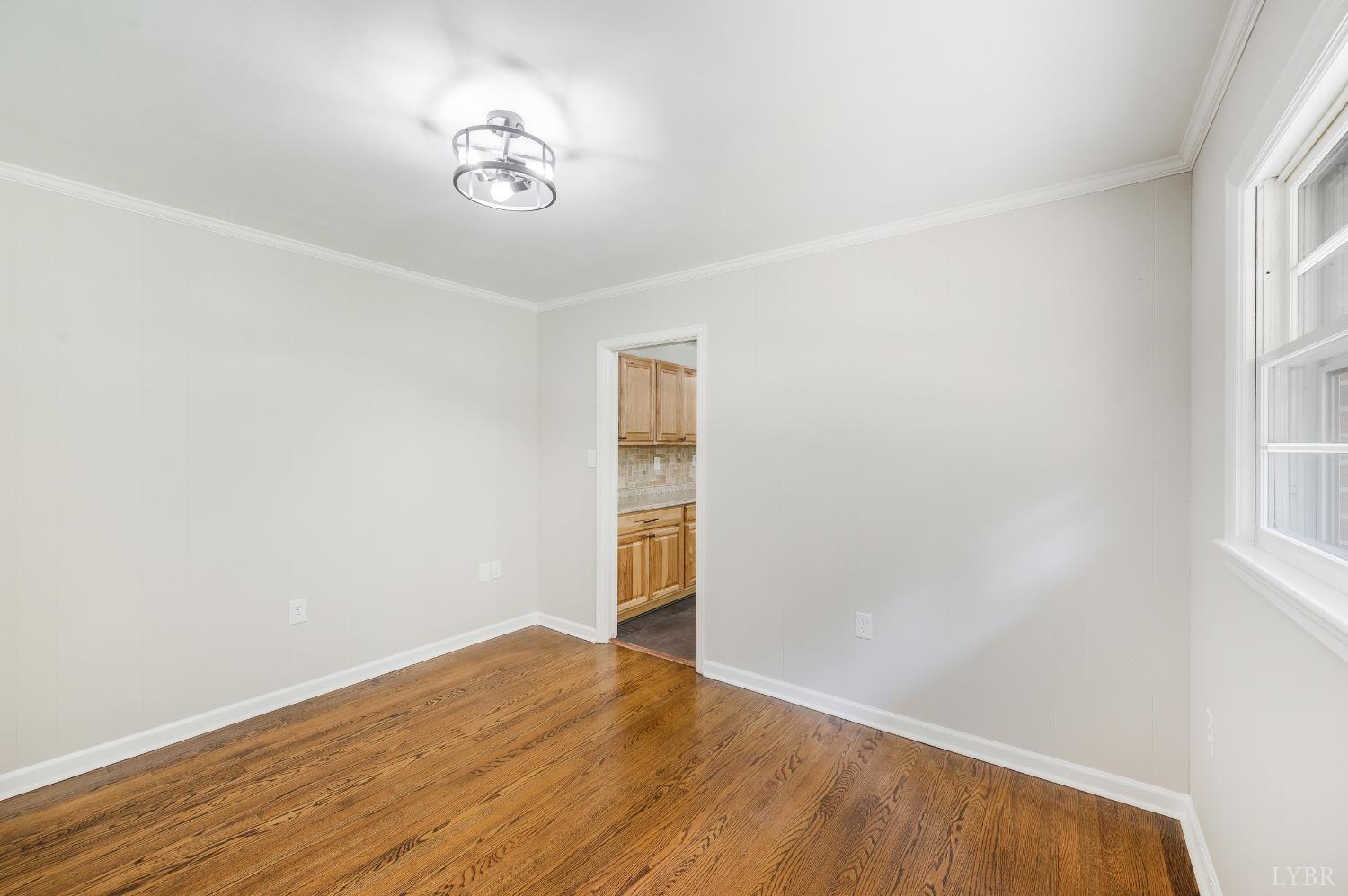 7230 Wards Road Rustburg, VA 24588 - Photo 22 of 58 an empty room with a window and wooden floor