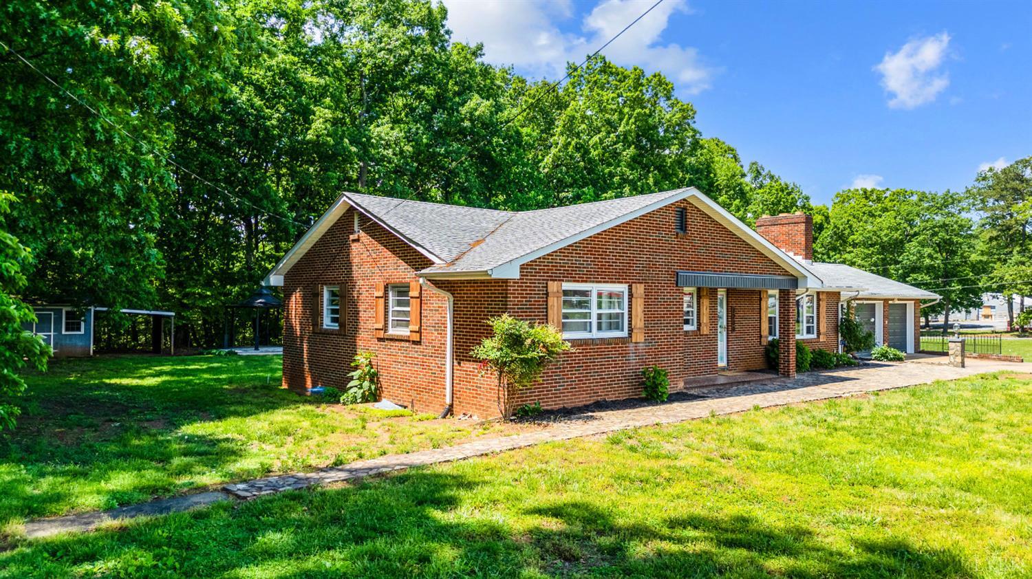 7230 Wards Road Rustburg, VA 24588 - Photo 3 of 58 a front view of a house with a yard and trees