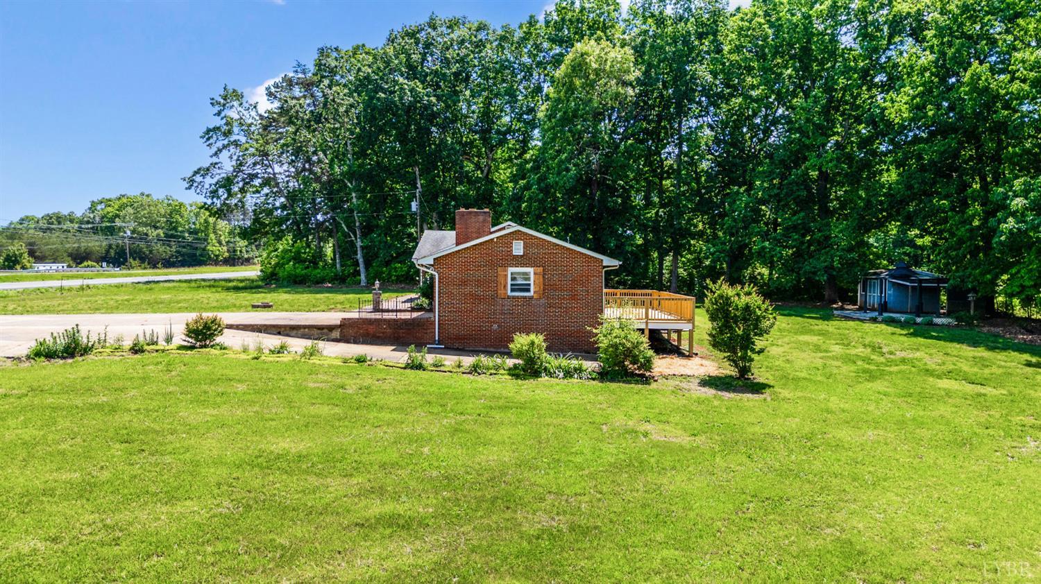 7230 Wards Road Rustburg, VA 24588 - Photo 7 of 58 a backyard of a house with table and chairs