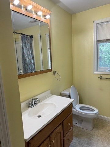 14 Moss Street, Unit 2 Burlington, MA 01803 - Photo 20 of 22 a bathroom with a toilet a sink and mirror