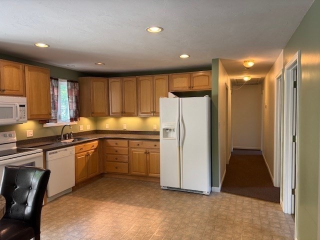 14 Moss Street, Unit 2 Burlington, MA 01803 - Photo 3 of 22 a kitchen with a refrigerator and a sink